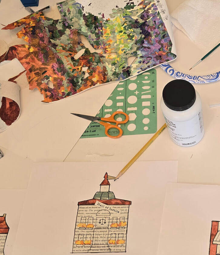 Lisa Hunter's art supplies orange handled scissors pencil brush container of glue and scraps of paper. Feather Road Design Studio, LLC